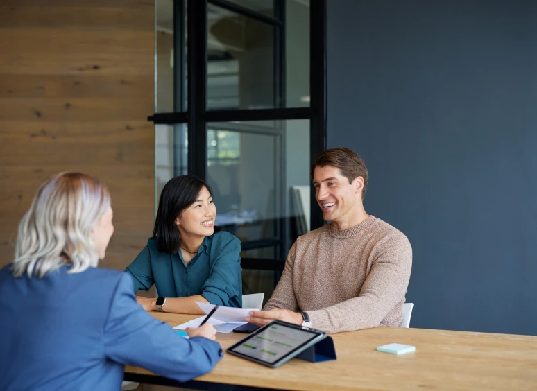 Three people having a business meeting.