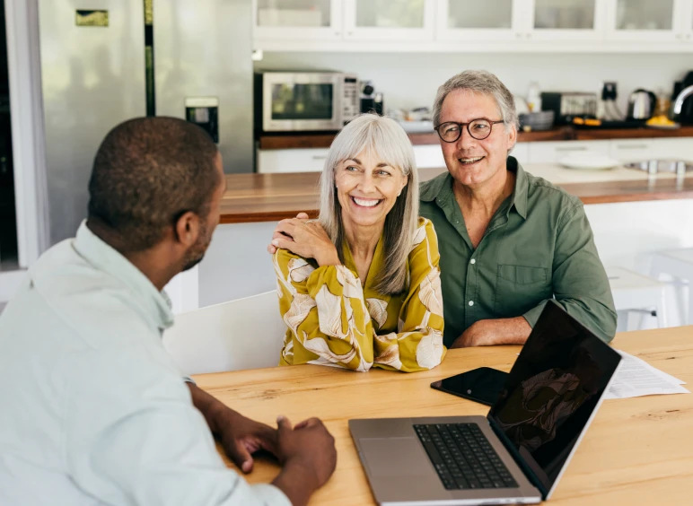 Couple meeting with advisor at home.