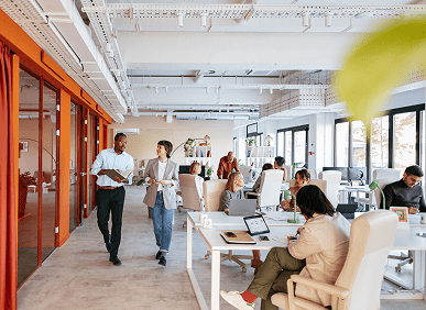 Open-plan office with people working collaboratively.