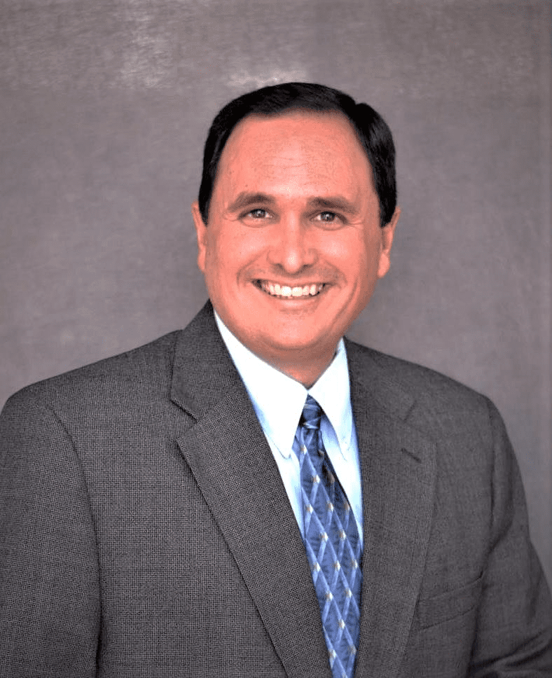 Smiling man in a suit and tie.
